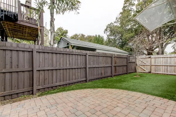 a view of a backyard with a wooden fence