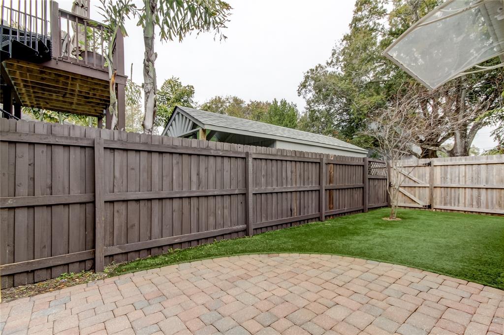2123 West Spruce Street Tampa, FL 33607 - Photo 34 of 40 a view of a backyard with a wooden fence