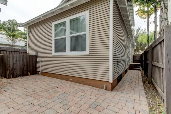 a view of a house with a yard and wooden fence