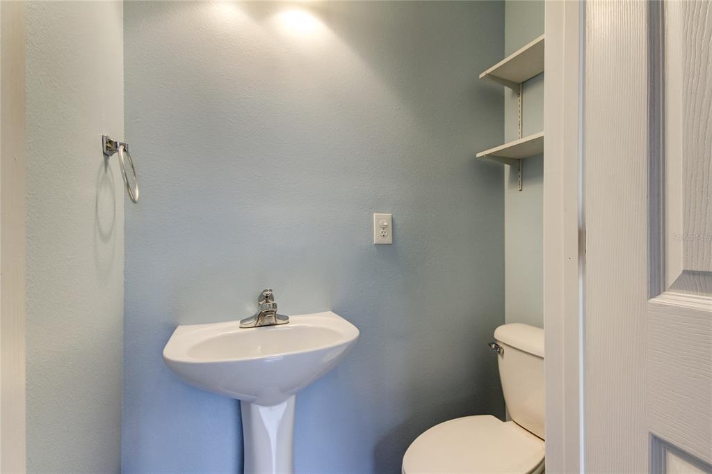 2123 West Spruce Street Tampa, FL 33607 - Photo 39 of 40 a bathroom with a toilet sink and mirror