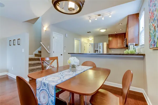 a view of a dining room with furniture and a potted plant