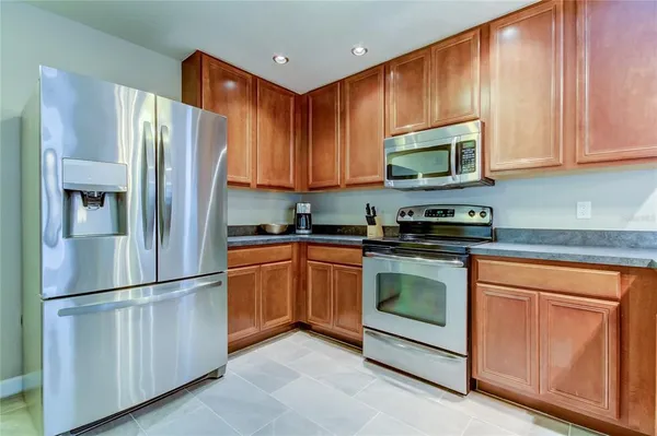 a kitchen with stainless steel appliances granite countertop a refrigerator stove a sink and dishwasher