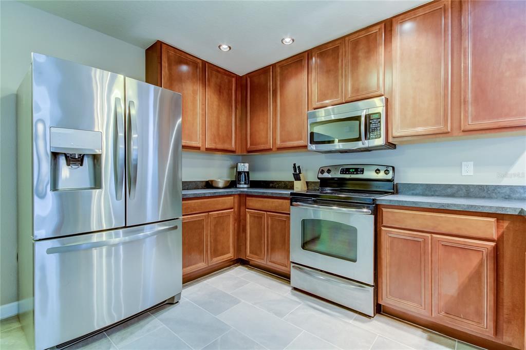 2123 West Spruce Street Tampa, FL 33607 - Photo 10 of 40 a kitchen with stainless steel appliances granite countertop a refrigerator stove a sink and dishwasher