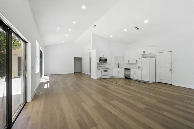 a view of a kitchen with wooden floor
