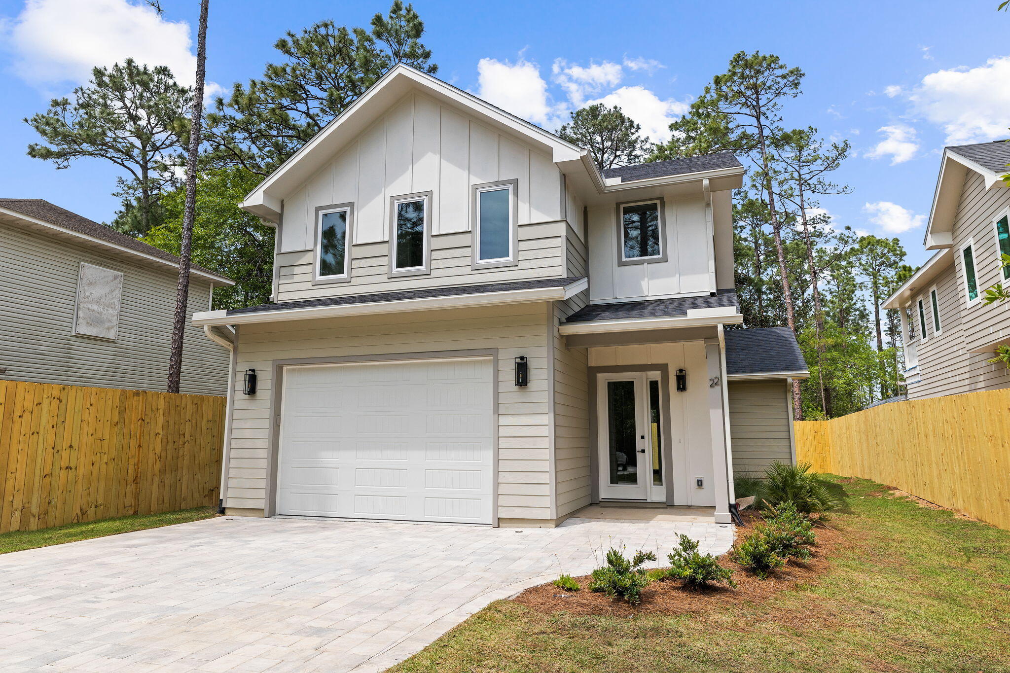 22 Georgie Street Point Washington, FL 32459 - Photo 9 of 57 a front view of a house with a yard and garage