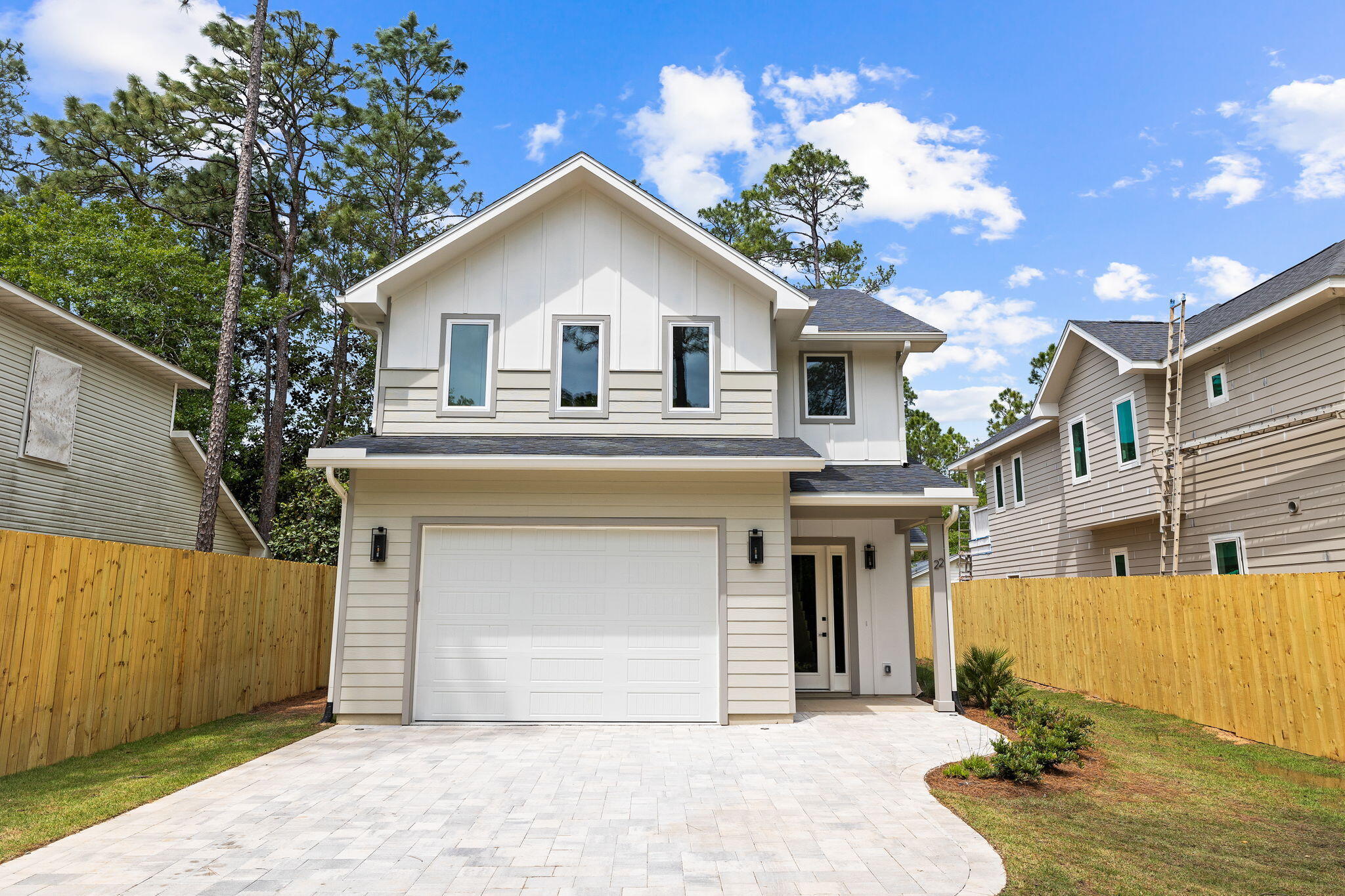 22 Georgie Street Point Washington, FL 32459 - Photo 11 of 57 a front view of a house with a yard and garage