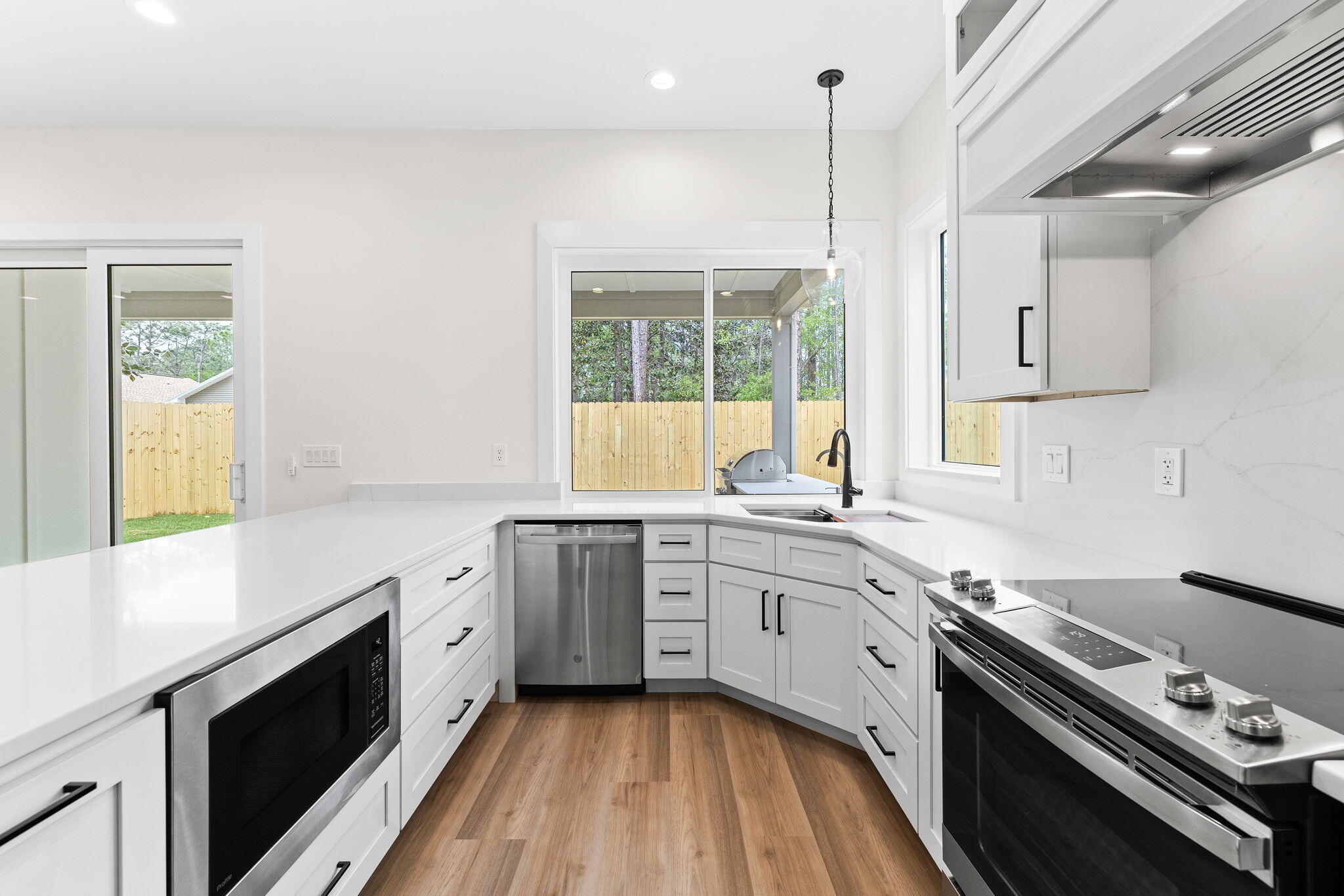 22 Georgie Street Point Washington, FL 32459 - Photo 25 of 57 a kitchen with a stove a sink and a window