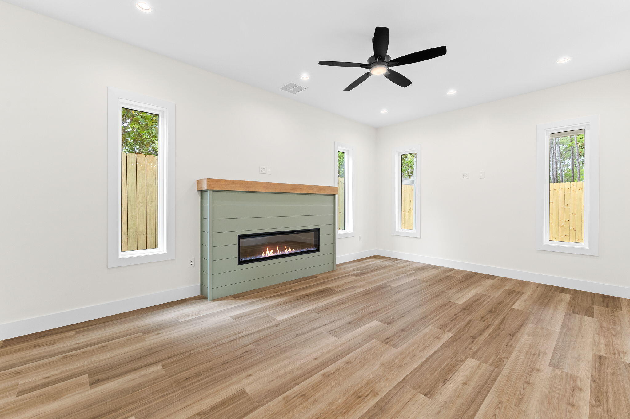 22 Georgie Street Point Washington, FL 32459 - Photo 32 of 57 a view of wooden floor fire place refrigerator and window in a room