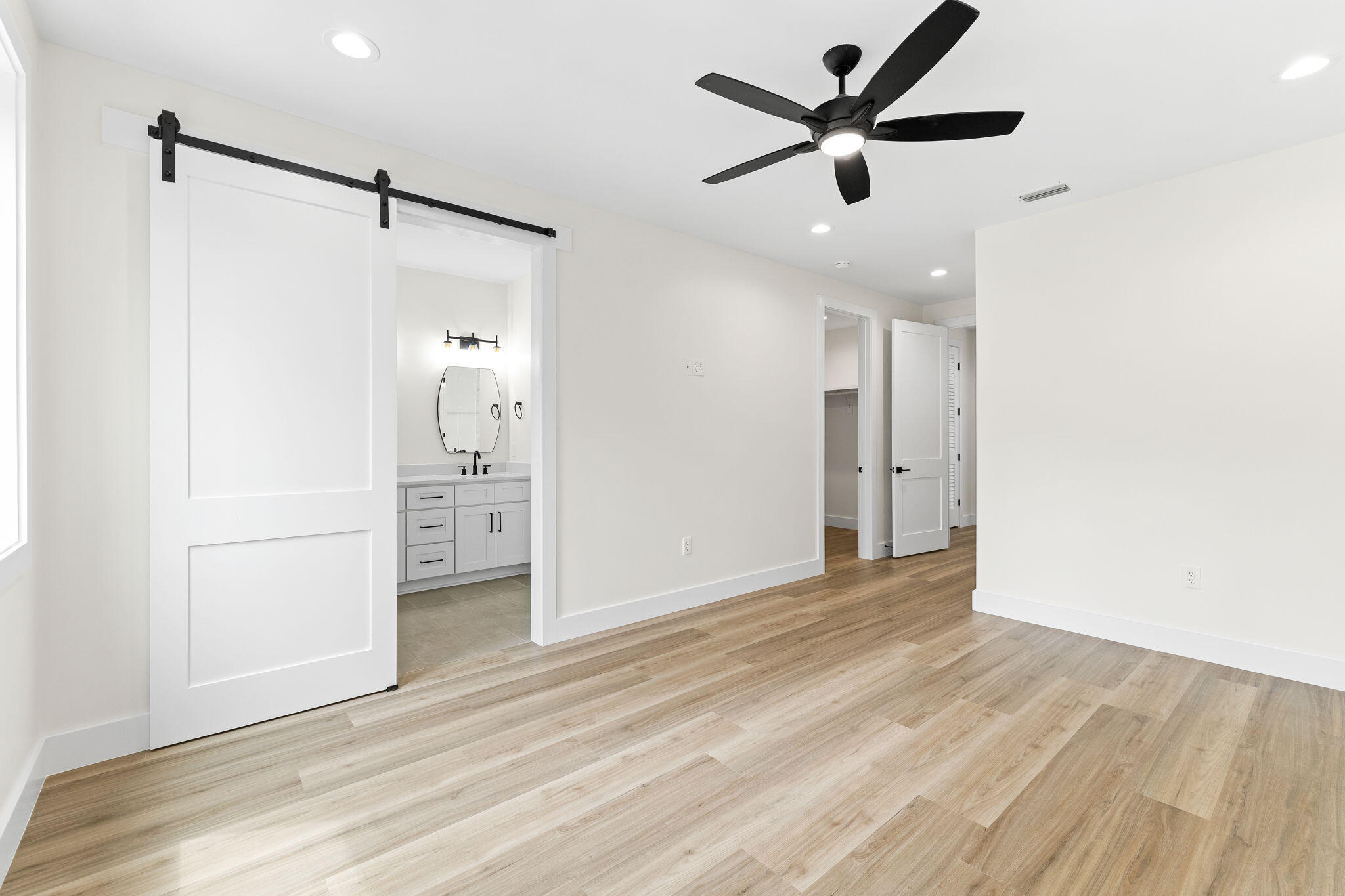 22 Georgie Street Point Washington, FL 32459 - Photo 44 of 57 a view of a big room with wooden floor and a ceiling fan