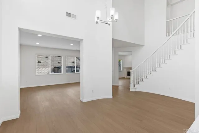a view of a room with wooden floor and staircase