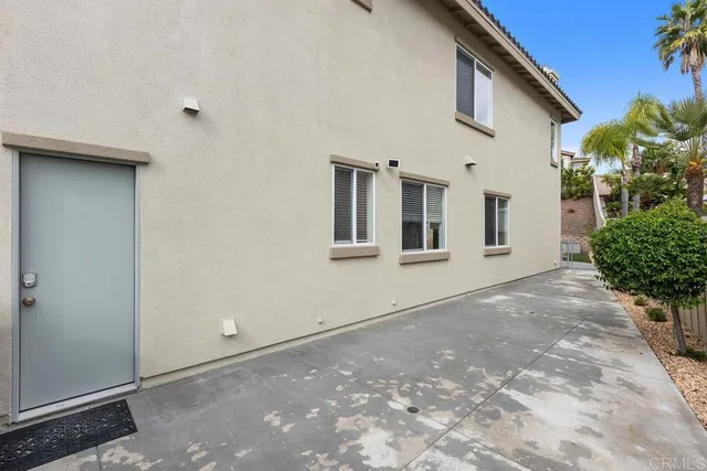 front view of a house with potted plants