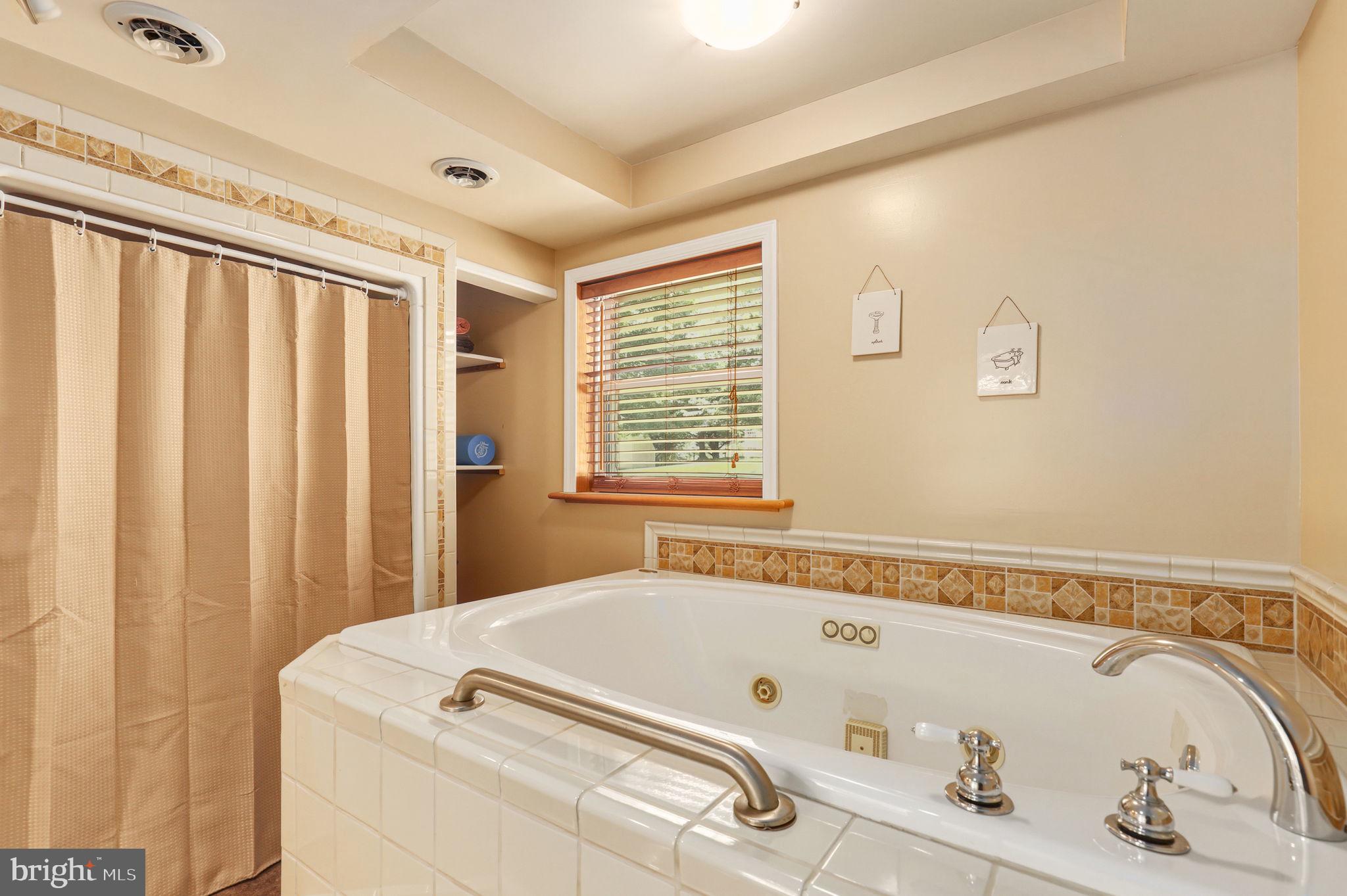 6336 Boyers Mill Road New Market, MD 21774 - Photo 30 of 49 a bathroom with a tub and a window