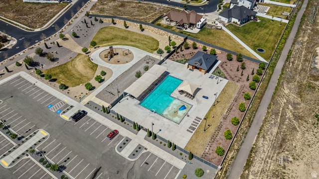 6120 North Sheps Ridge Road Eagle Mountain, UT 84005 - Photo 38 of 43 Community recreation area featuring a large swimming pool, separate children's splash pad, and a shaded pergola