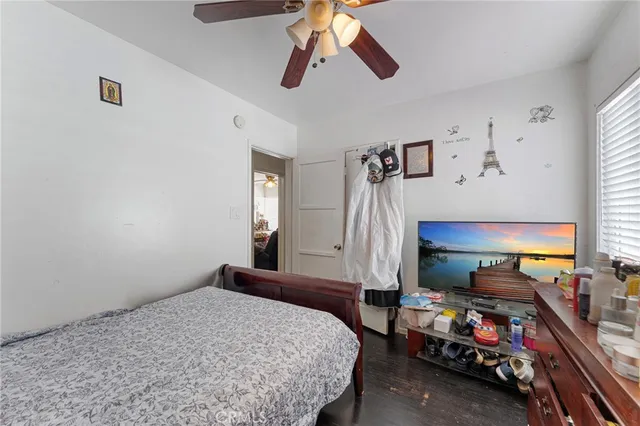 a bedroom with bed and window