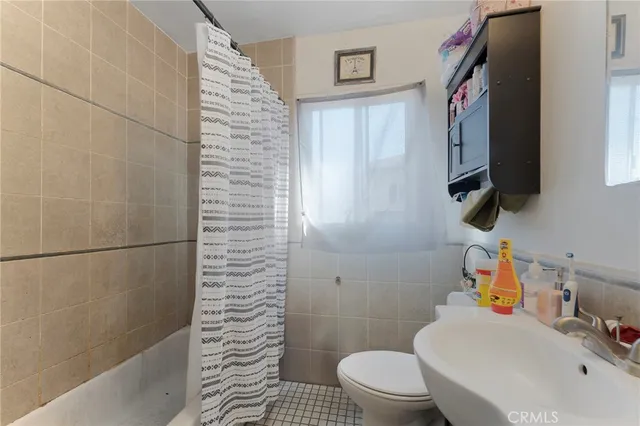 a bathroom with a sink a toilet and a shower