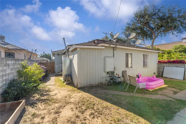 a backyard of a house with table and chairs