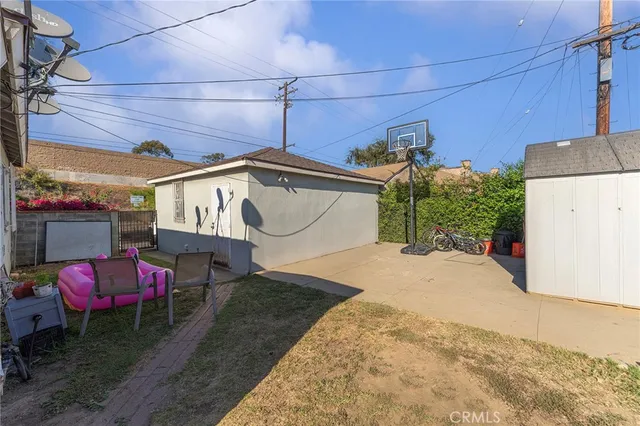 a view of a backyard with table and chairs under an umbrella