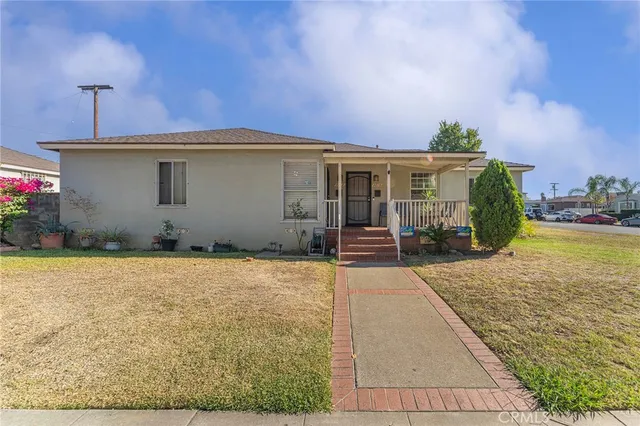 a backyard of a house with yard and outdoor seating