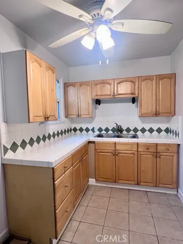 a kitchen with granite countertop a sink and cabinets