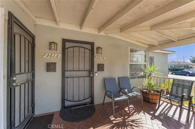 a living room with furniture a window and wooden floor
