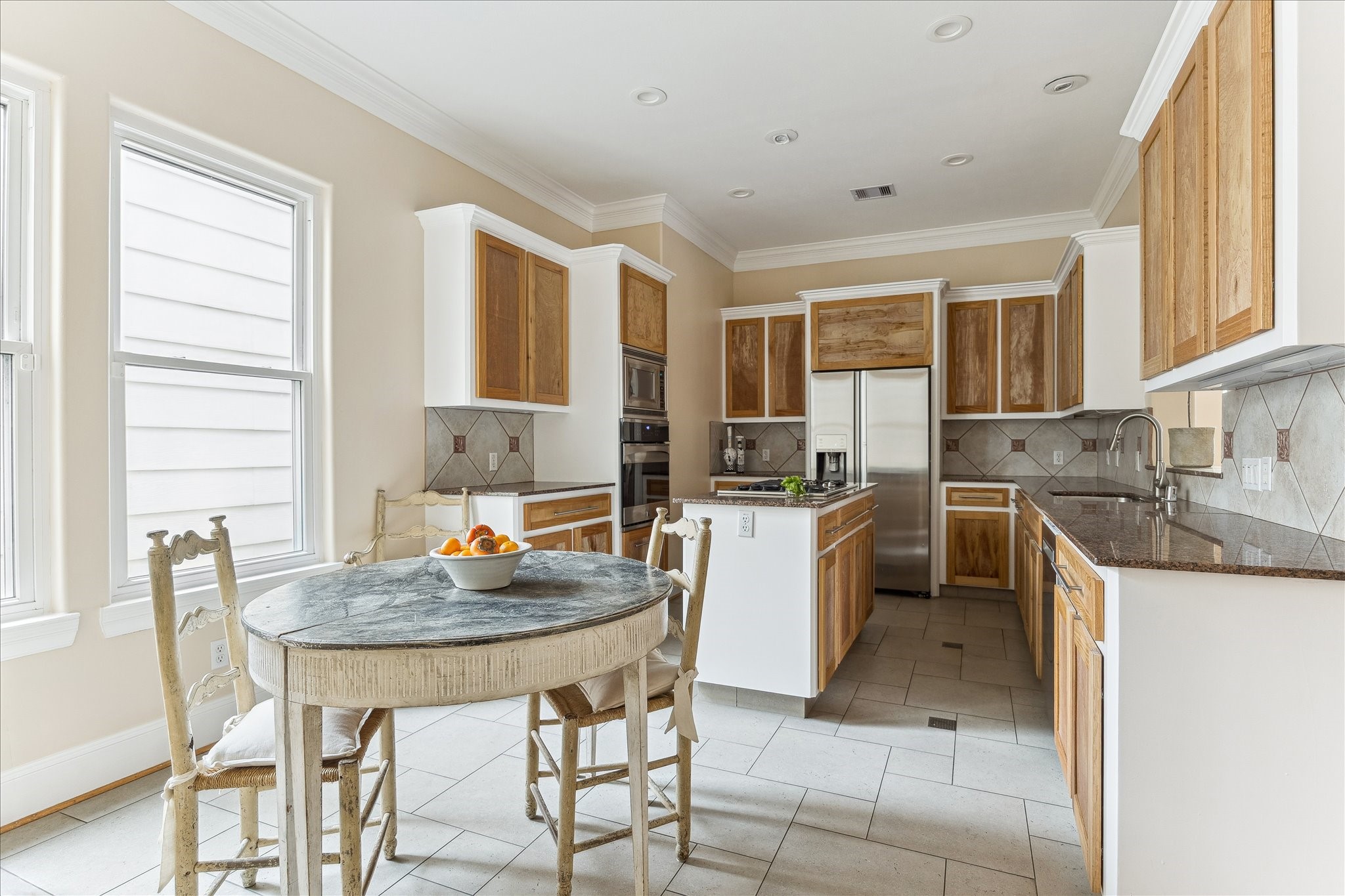 3515 Yupon Street Houston, TX 77006 - Photo 15 of 41 a kitchen with a table chairs sink and cabinets