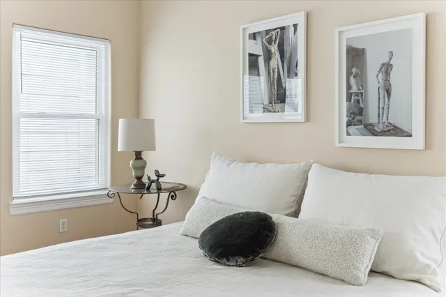 a spacious bedroom with a large bed and a window