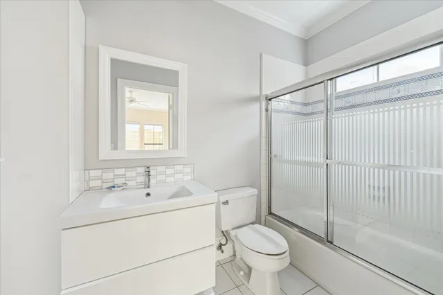 a spacious bedroom with a bed a couch and a large window