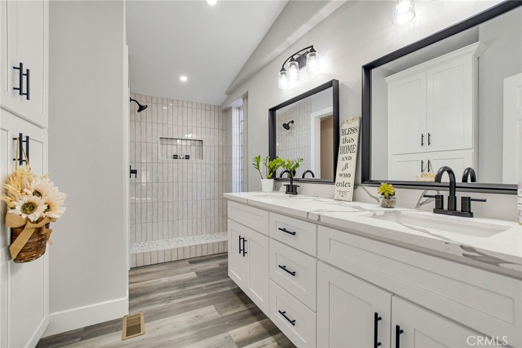 25534 Zuni Road Apple Valley, CA 92307 - Photo 1 of 1 a bathroom with a double vanity sink mirror and shower