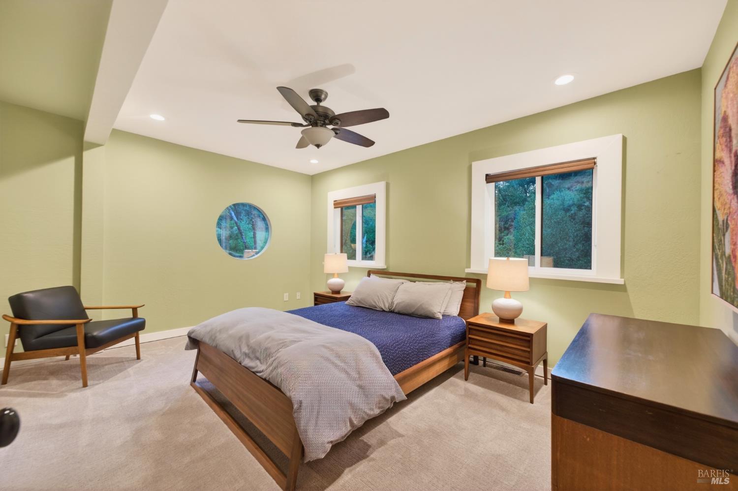 116 Hill Road Glen Ellen, CA 95442 - Photo 18 of 48 Main floor bedroom with multiple windows, including a porthole window.
