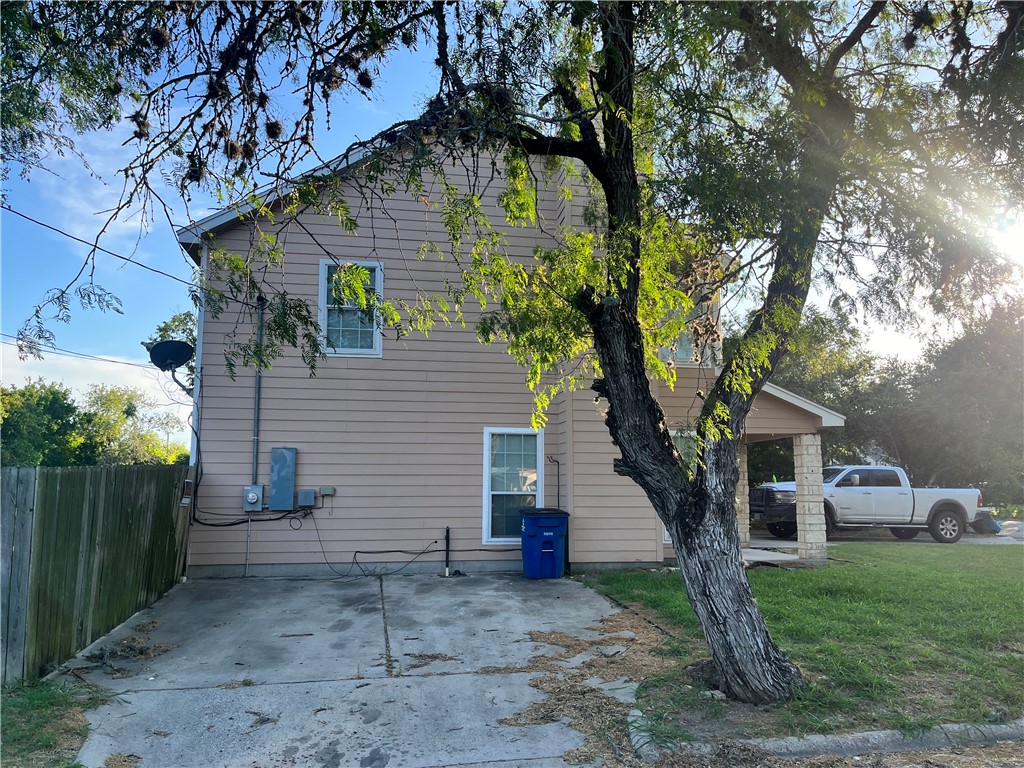 908 East Hefferman Street Beeville, TX 78102 - Photo 6 of 40 a house that has a tree in front of the house