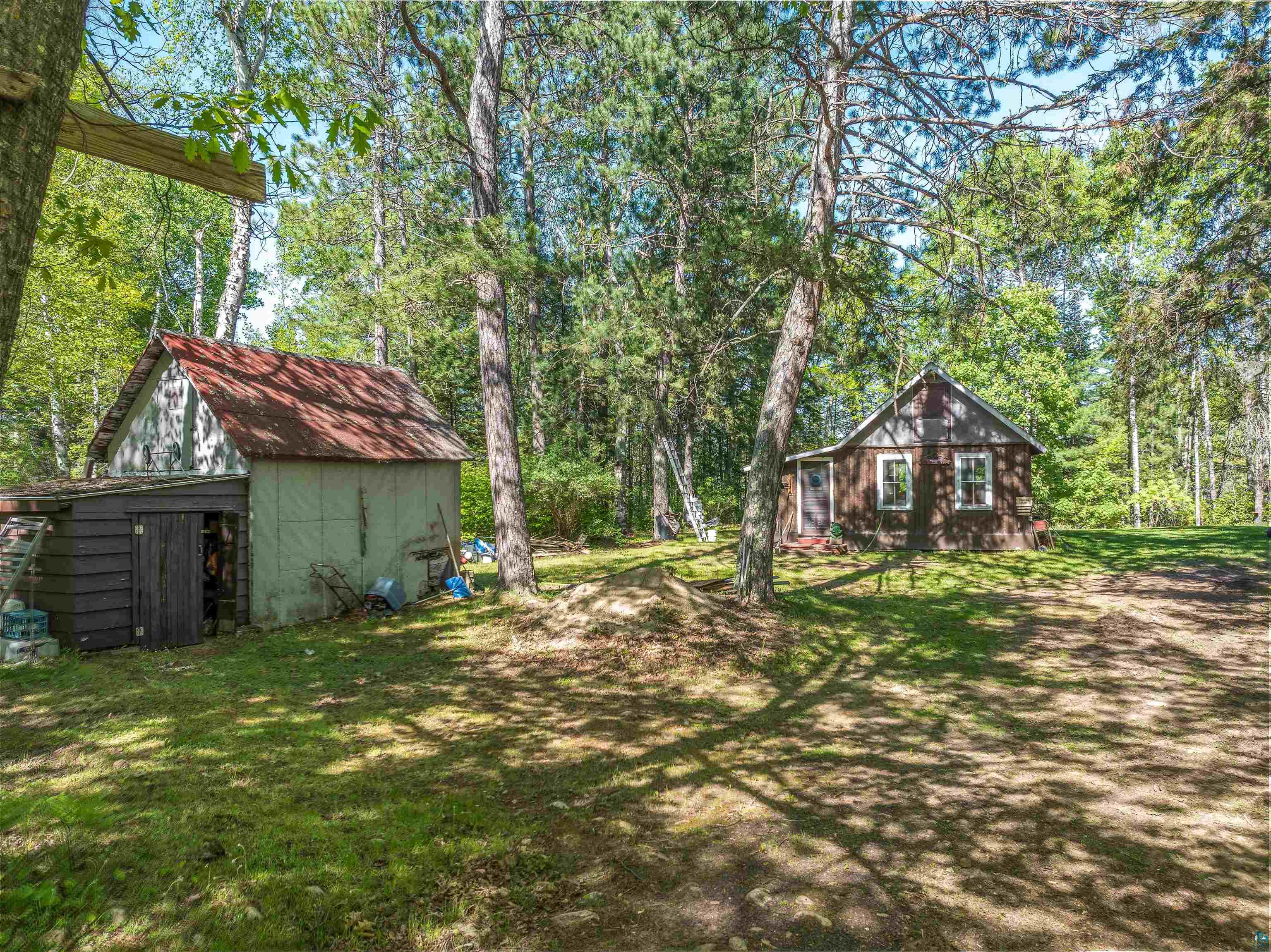9064 Peppard Road Britt, MN 55710 - Photo 29 of 40 Rustic cabin exterior surrounded by mature trees