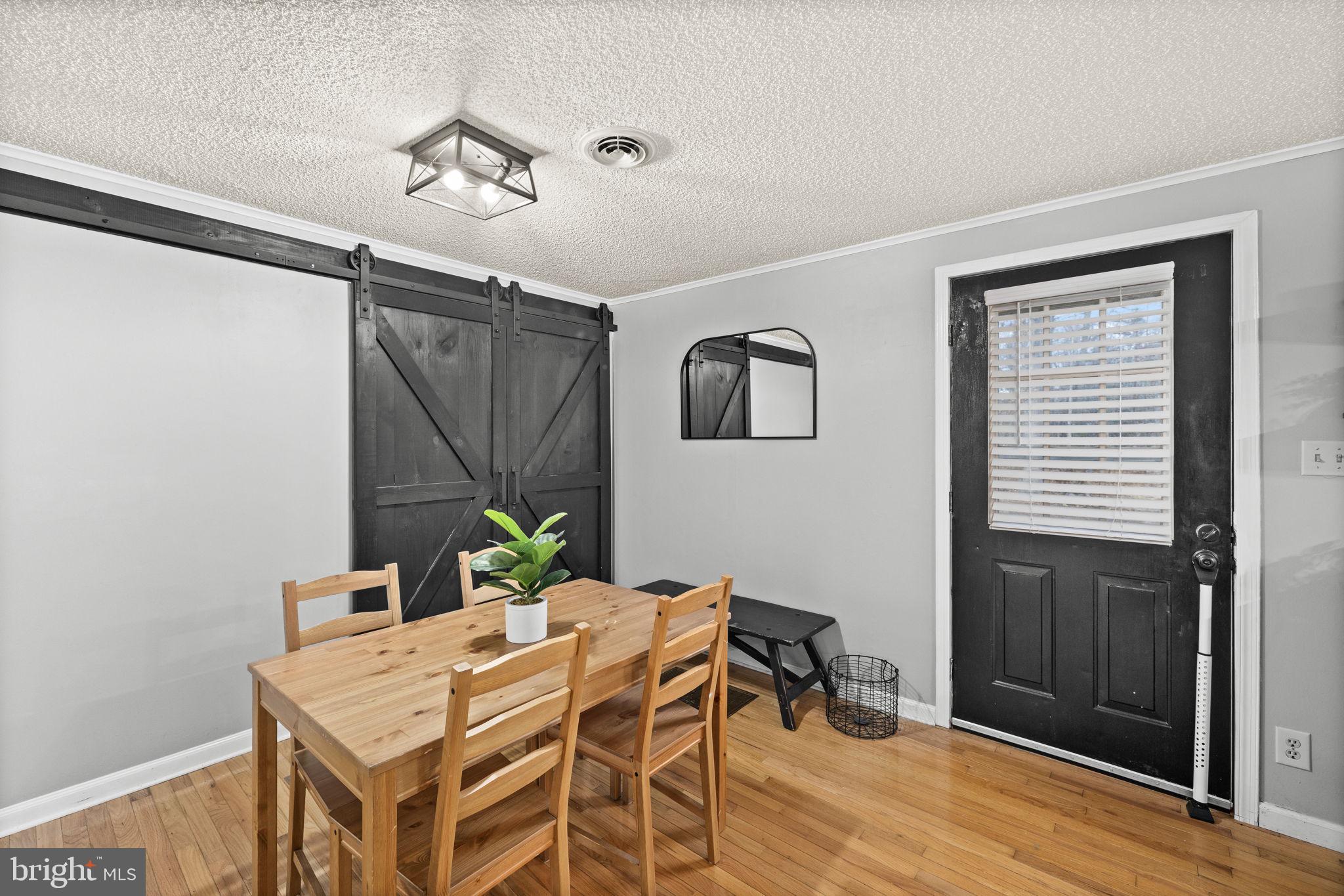 9523 Brock Road Spotsylvania, VA 22553 - Photo 13 of 44 a view of a dining room with furniture and wooden floor