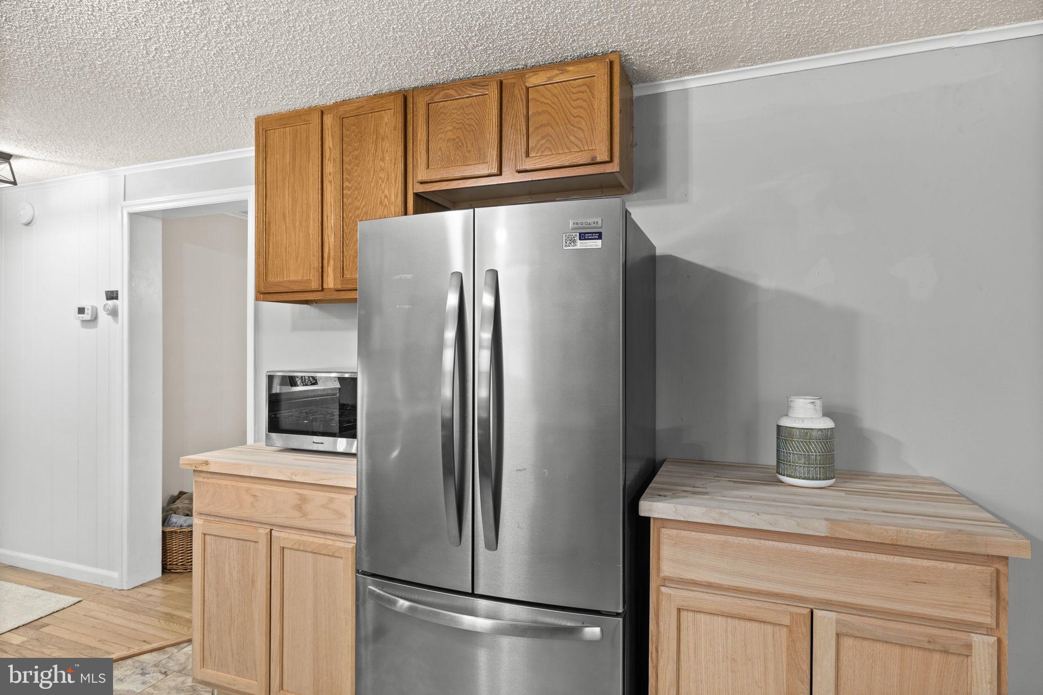 9523 Brock Road Spotsylvania, VA 22553 - Photo 21 of 44 a kitchen with stainless steel appliances a refrigerator and cabinets