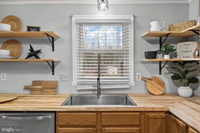 a kitchen with stainless steel appliances granite countertop a sink and a window