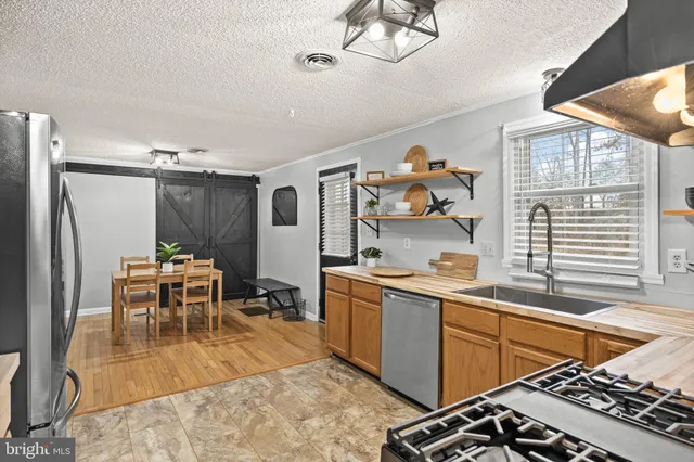 a kitchen with a sink and a stove top oven