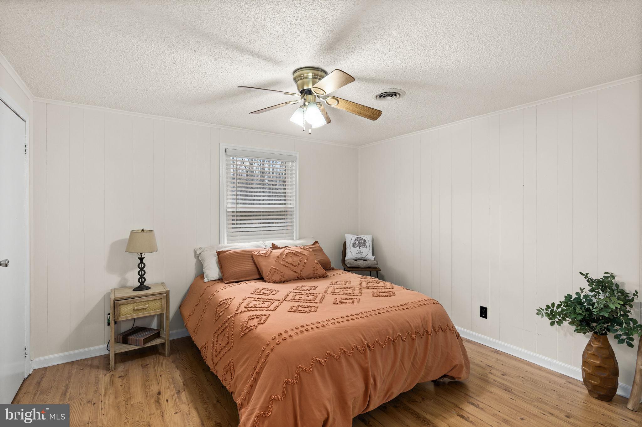 9523 Brock Road Spotsylvania, VA 22553 - Photo 26 of 44 a bedroom with a bed and a potted plant