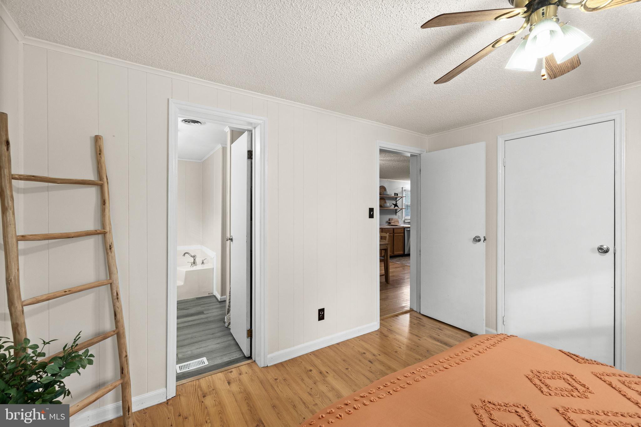 9523 Brock Road Spotsylvania, VA 22553 - Photo 27 of 44 a bedroom with a bed and a chandelier