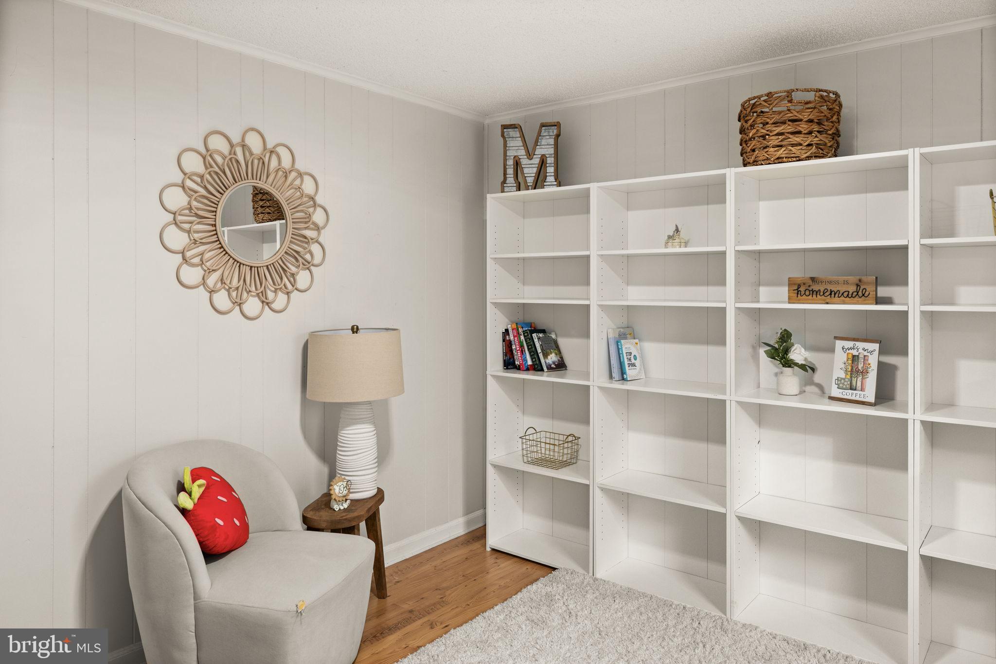 9523 Brock Road Spotsylvania, VA 22553 - Photo 34 of 44 a living room with a book shelf and a shelf