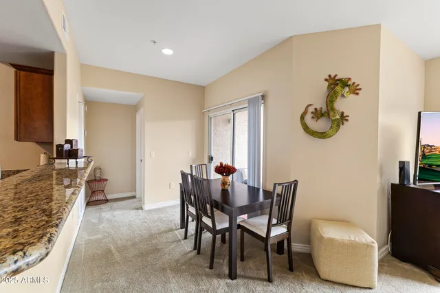 a dining room with furniture and a rug