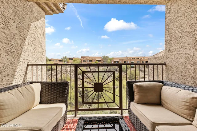 a balcony with a couch and wooden floor