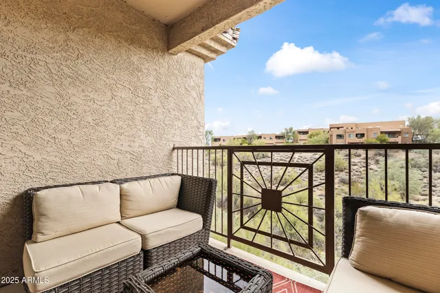 a balcony with wooden floor and city view