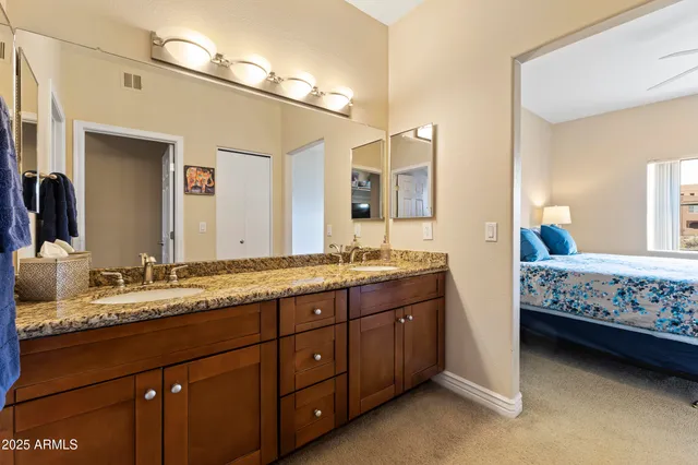 a bathroom with a double vanity sink and a mirror