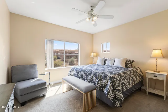 a bedroom with a bed a couch and a window