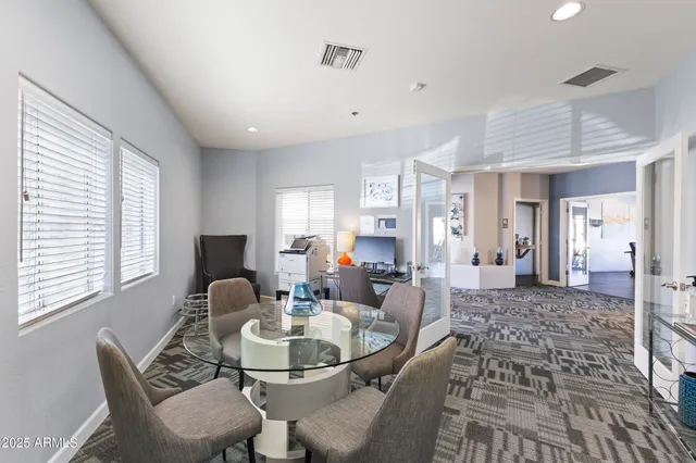a living room with furniture a dining table and chairs
