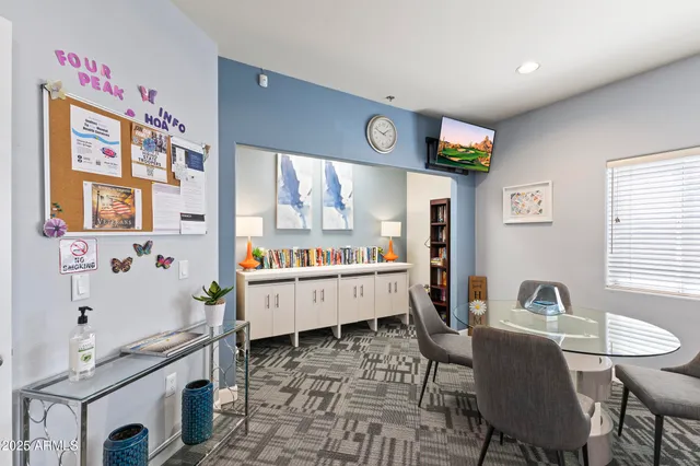 a kitchen with stainless steel appliances kitchen island granite countertop a table chairs in it and a window