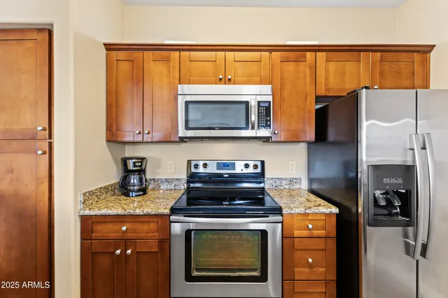 a kitchen with a refrigerator stove and microwave