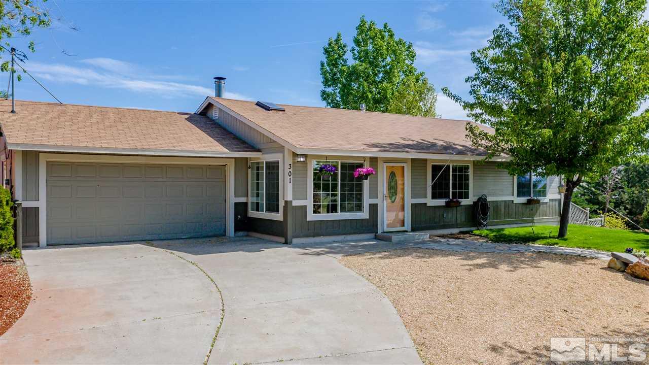 301 Hoge Road Reno, NV 89506 - Photo 1 of 23 a front view of a house with a garden and porch