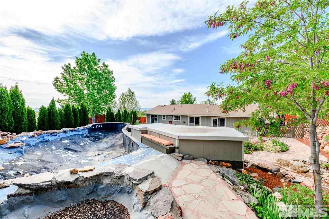 301 Hoge Road Reno, NV 89506 - Photo 19 of 23 a view of a terrace with chairs and wooden fence