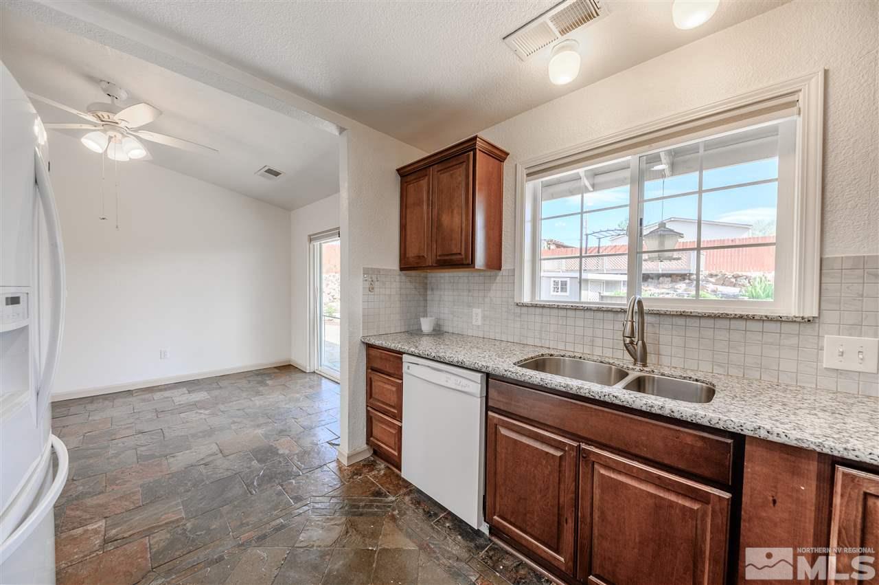 301 Hoge Road Reno, NV 89506 - Photo 9 of 23 a kitchen that has a sink a window and cabinets
