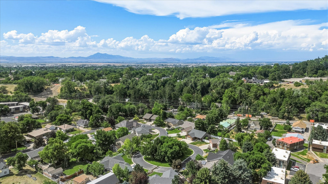 689 Apple Drive Logan, UT 84321 - Photo 47 of 52 Expansive aerial perspective showcasing a residential neighborhood with mature trees